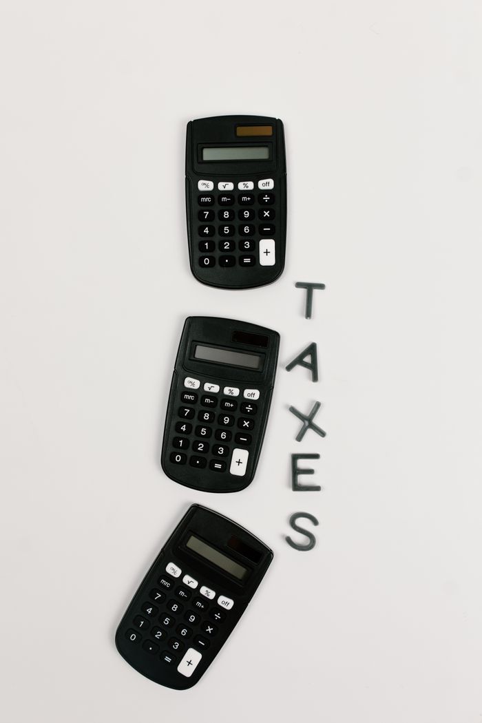 Crafting Captivating Headlines: Your awesome post title goes here Flat lay of three calculators with 'TAXES' text on a white background.