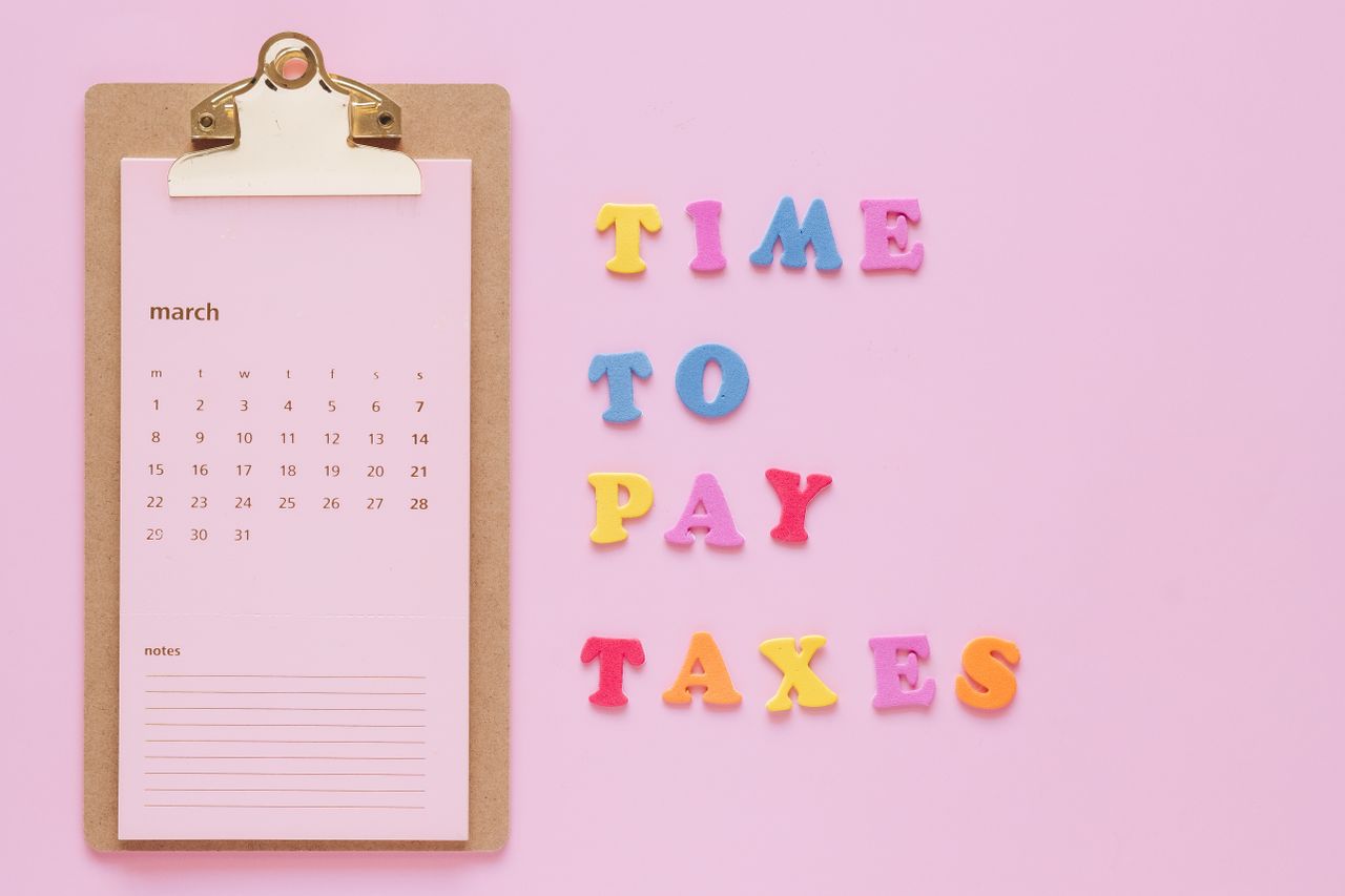 The Art of Drawing Readers In: Your attractive post title goes here Colorful tax reminder on clipboard against a pink background for March